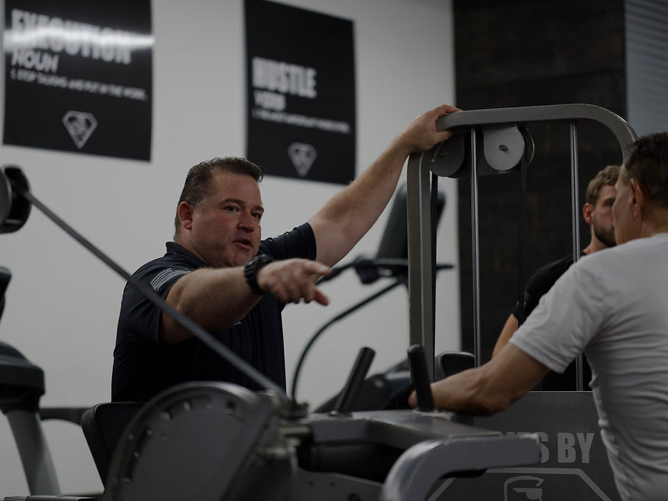 Adam coaching a client through an exercise